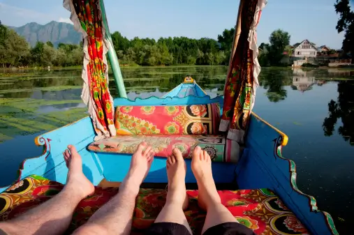 A family on trip to kashmir and enjoyong iconic shikara ride on nigeen lake, a part of srinagar Dal Lake