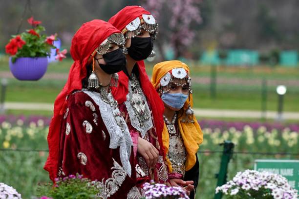 Children posing beside tulip displays at Kashmir’s annual Tulip Festival in Indira Gandhi Garden